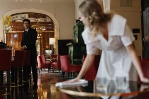 How to be a Successful Waiter/Waitress Certification - A waiter and waitress in a stylish restaurant setting, focusing on service and elegance.