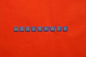 Microsoft Word Certificate Level 2 - Blue letter tiles spelling 'Workspace' on a vibrant red background.