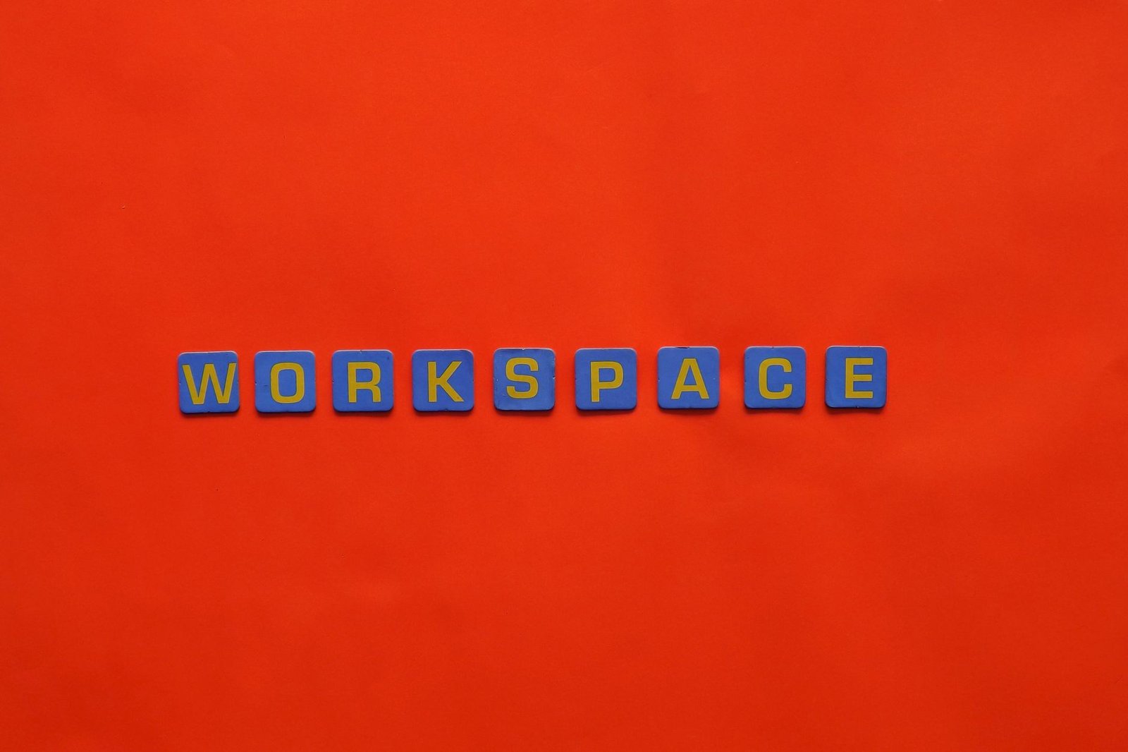 Microsoft Word Certificate Level 2 - Blue letter tiles spelling 'Workspace' on a vibrant red background.