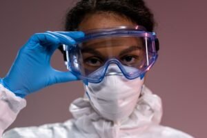 Eye Safety in the Workplace Certification - Close-up portrait of a healthcare worker wearing full protective equipment, eyeglasses, mask, and gloves.