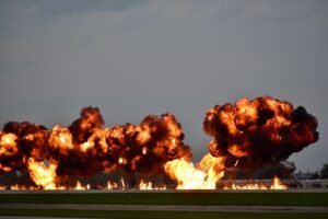 Fires and Explosions in the Workplace Certification - Dramatic explosion during airshow in Oshkosh, Wisconsin showcasing flames and smoke.